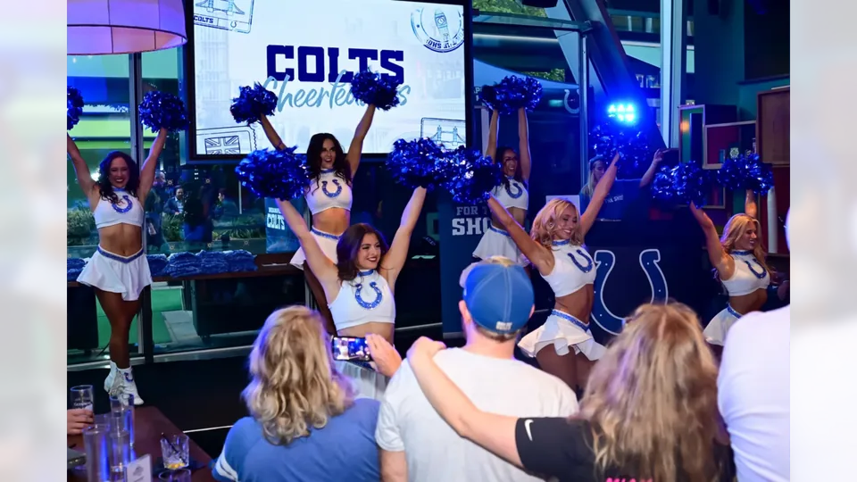 Colts Cheerleaders and fans beside the DJ booth at Greenwood