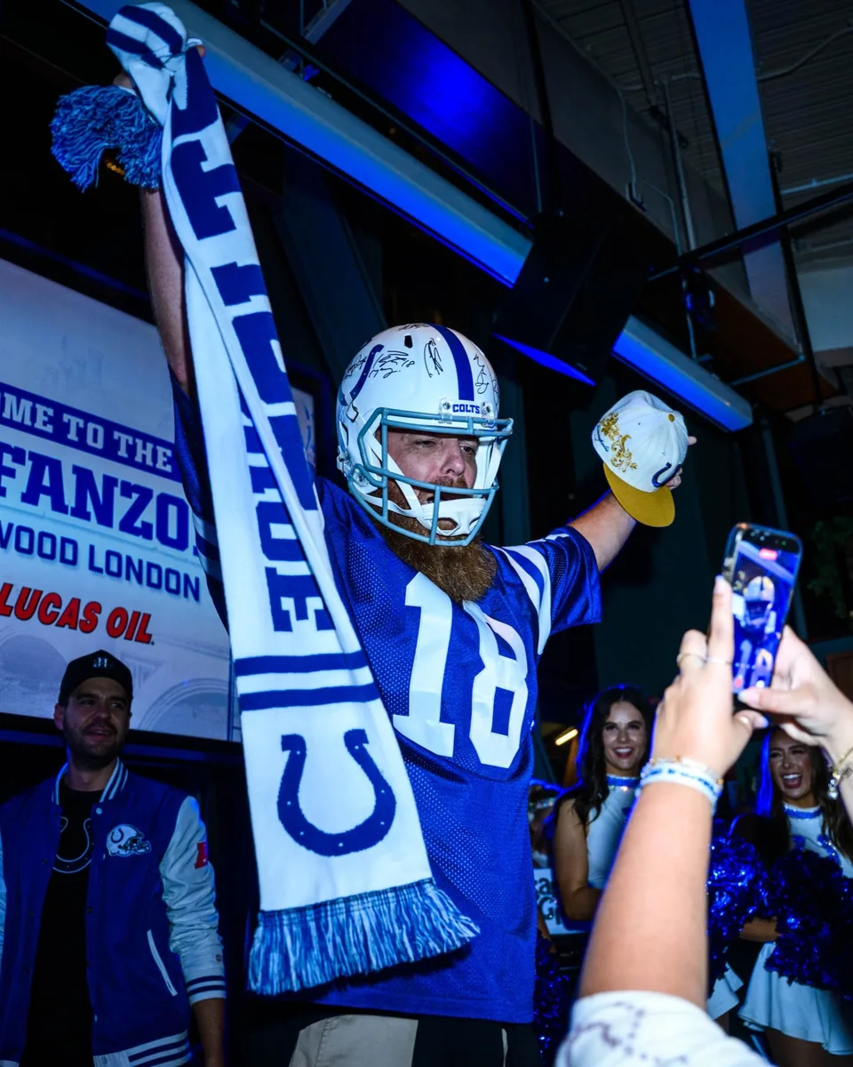 Colts supporter raising a scarf at Greenwood in London