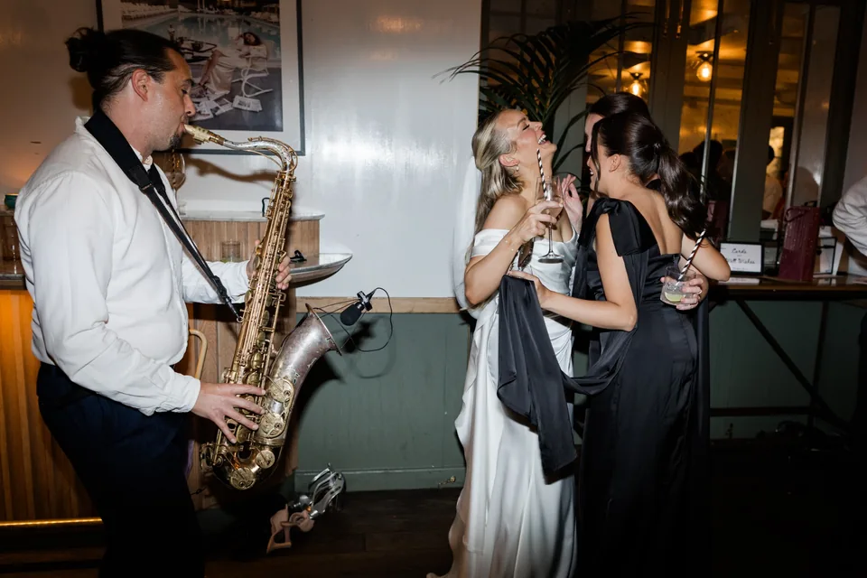 Bride and guests enjoying live sax at The Italian Greyhound wedding