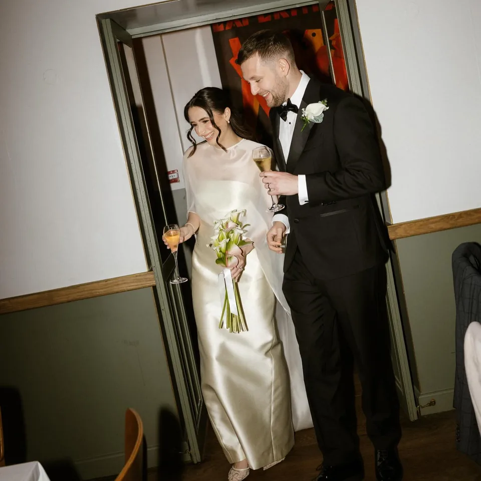 Newly married couple entering their wedding reception at The Italian Greyhound