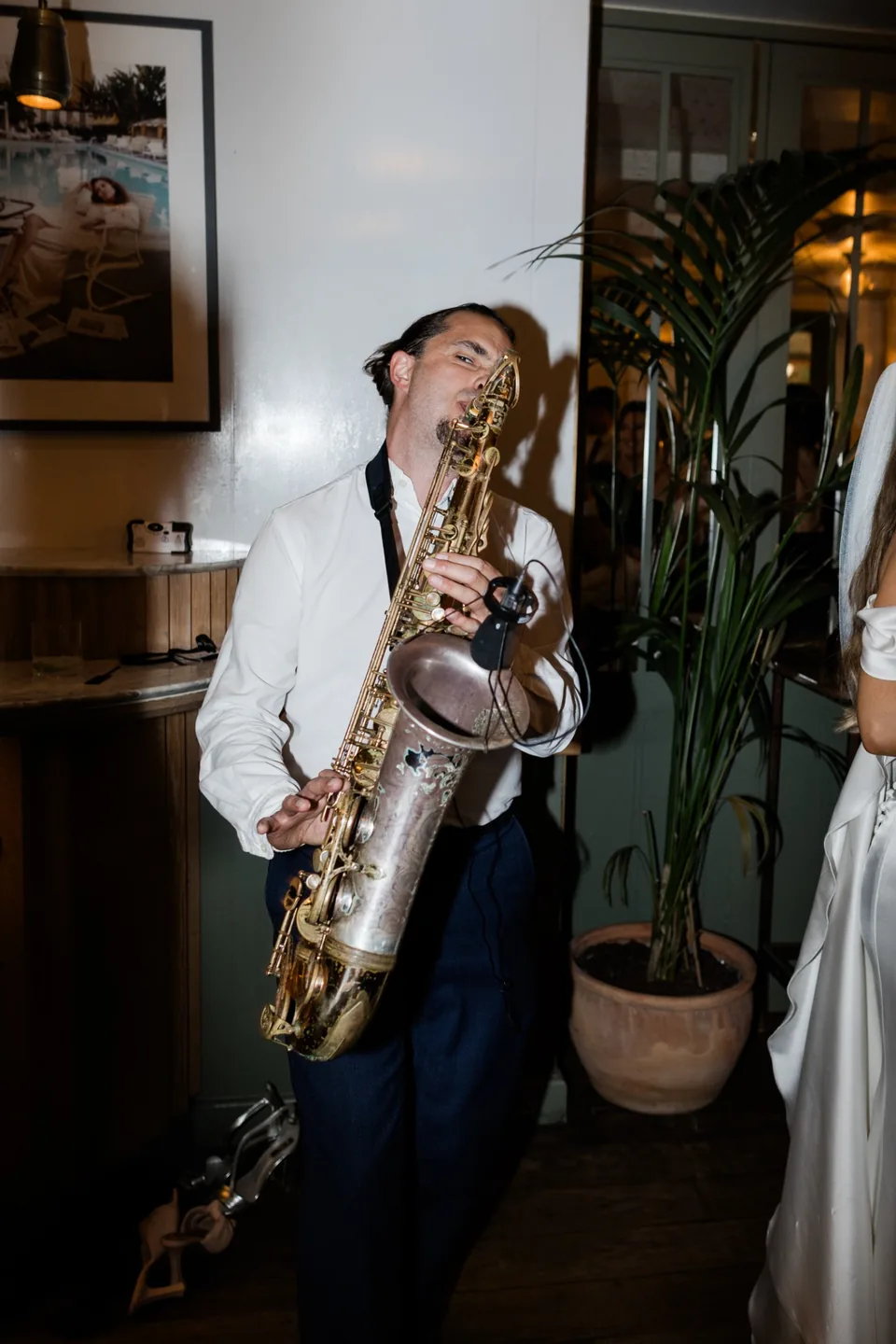 Live saxophonist performing among wedding guests at The Italian Greyhound