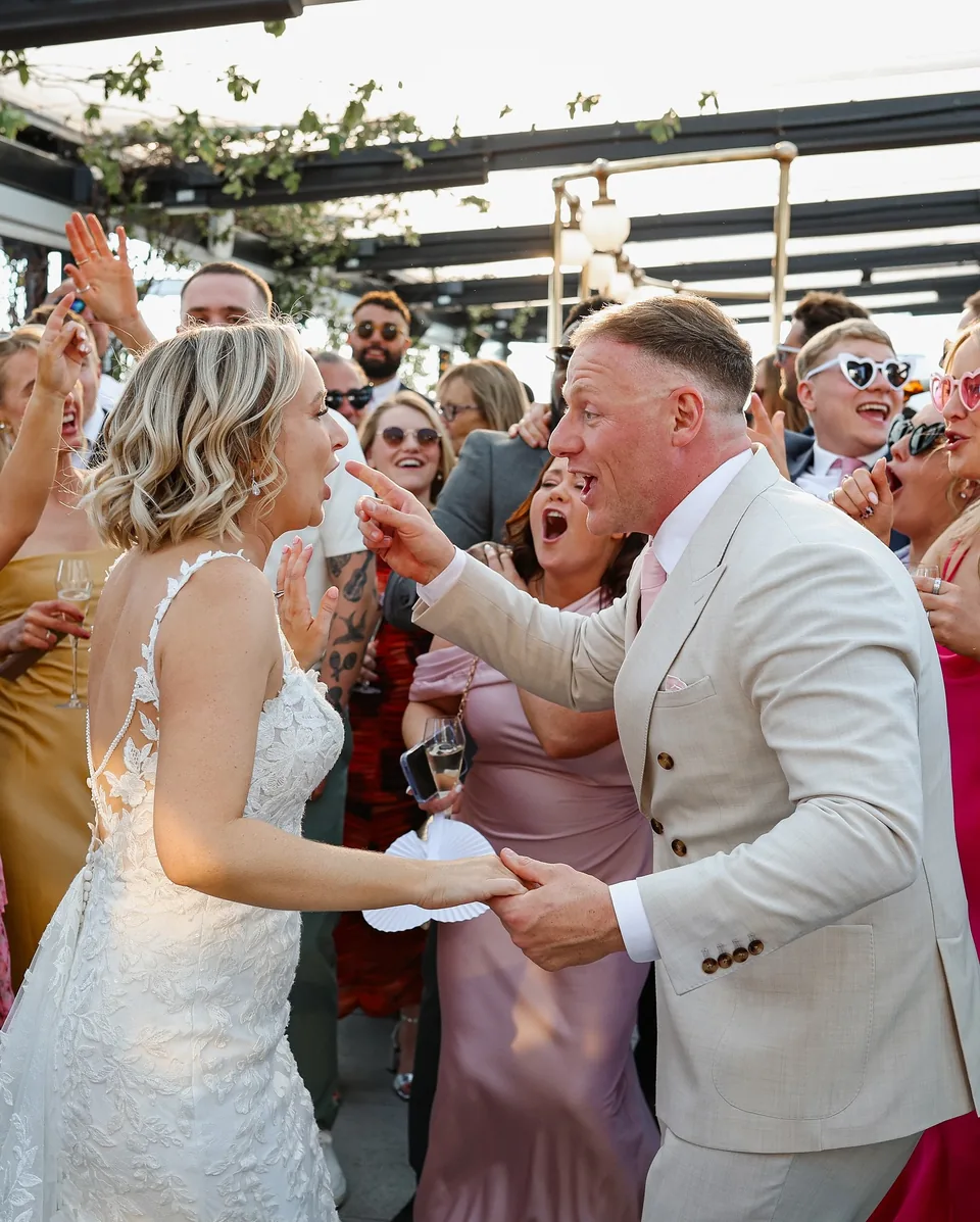 Newly married couple dancing with guests at Wagtail