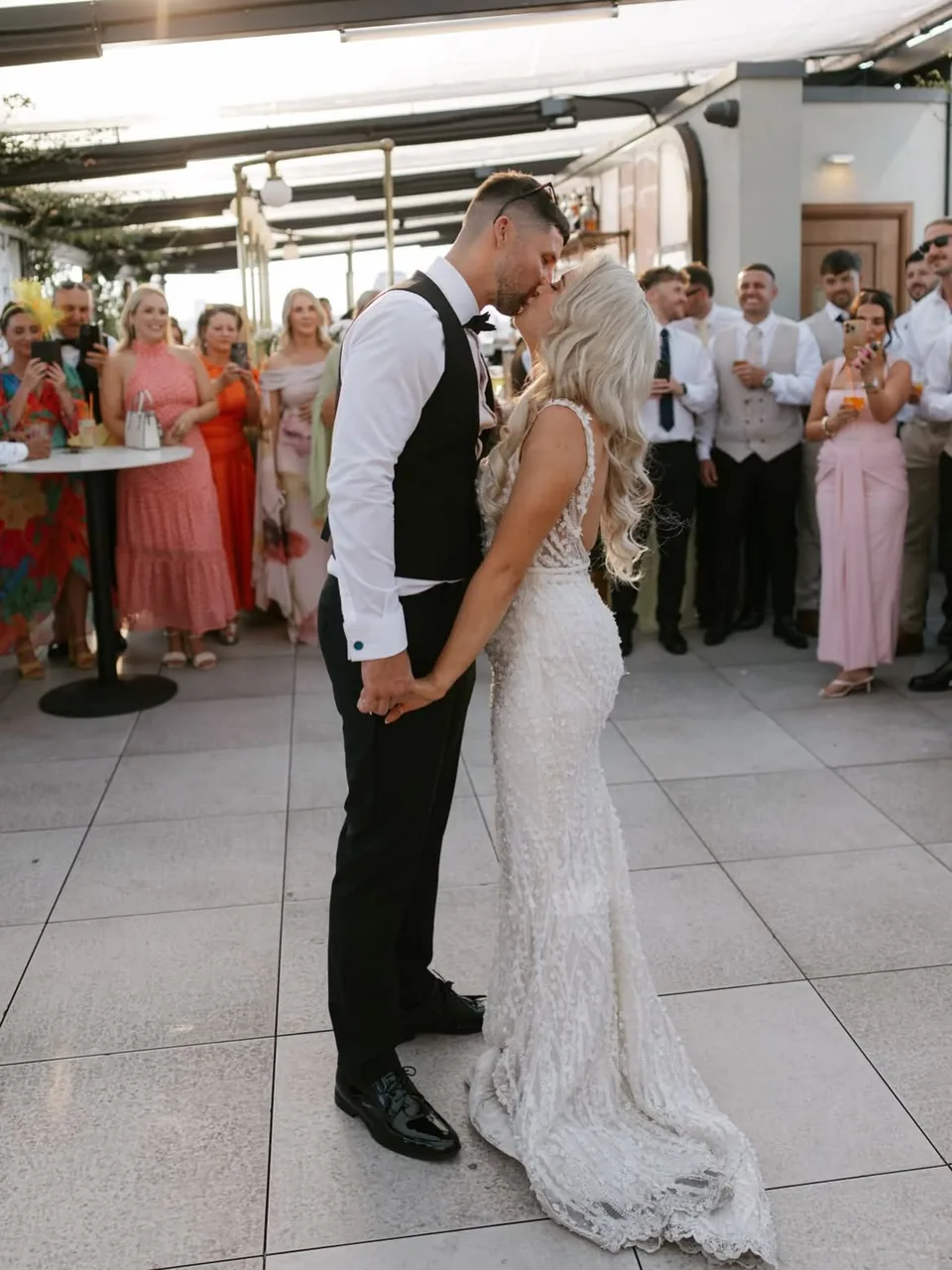 Newly married couple kissing on the rooftop terrace at Wagtail London