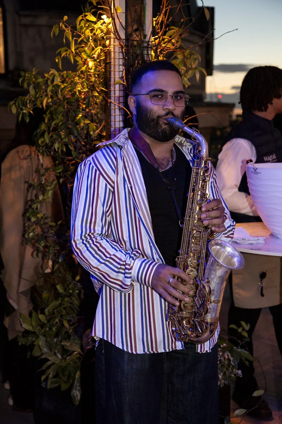 Saxophonist performing among guests at the Wagtail corporate event